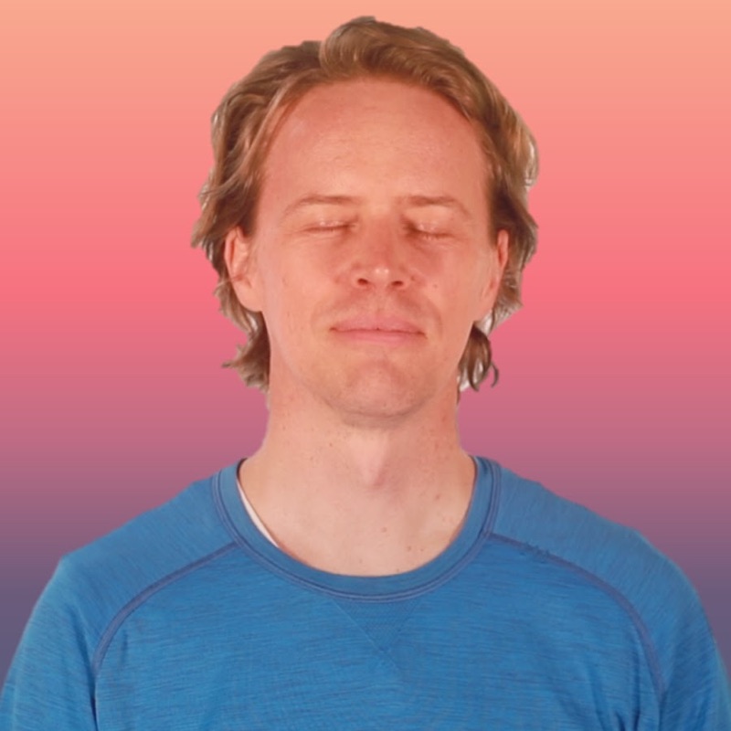 Nate meditating with his eyes closed, in a blue shirt against a pink and purple background